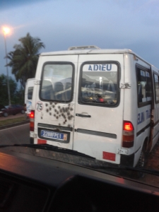 One of the many busses with "Dieu", many other have Bible verses on them. Ignore the bullet holes.
